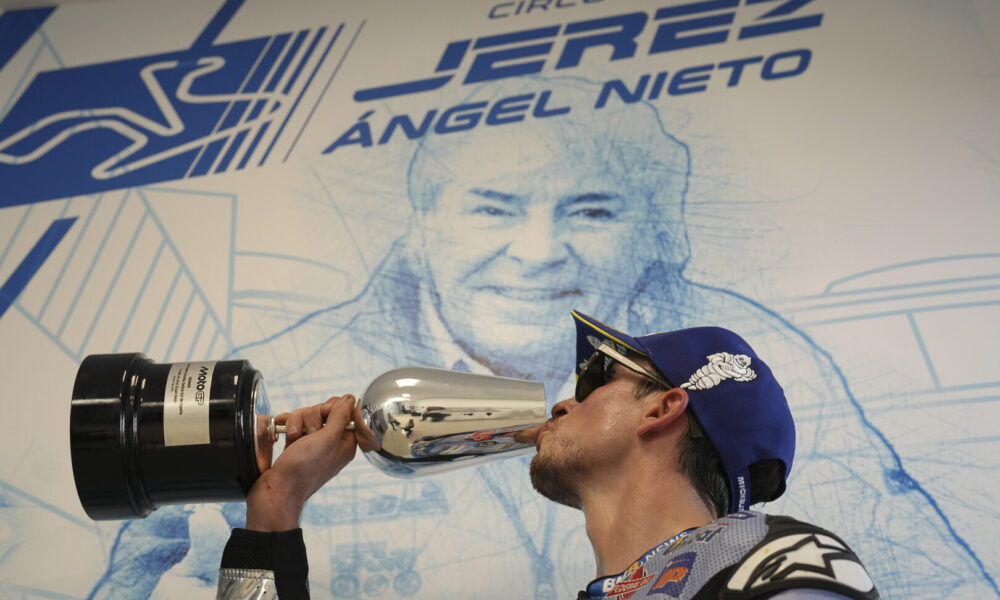 Alex Marquez celebrates on the podium after winning his first race inn MotoGP.
