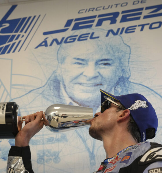 Alex Marquez celebrates on the podium after winning his first race inn MotoGP.