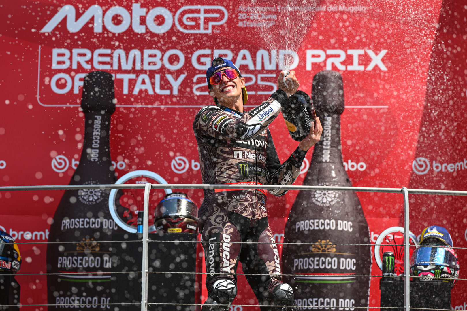 Marc Marquez celebrates on the podium after winning the MotoGP Grand Prix of Mugello